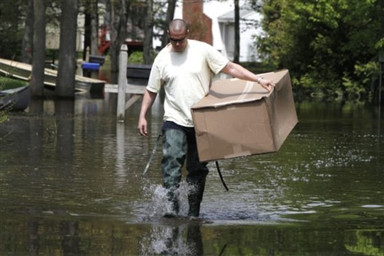 Jim Brault walks down a flooded street to his home in Colchester, Vt., on May 25.&nbsp;Hundreds of residents&nbsp; are caught in the slow-moving catastrophe that is Lake Champlain's flooding. 